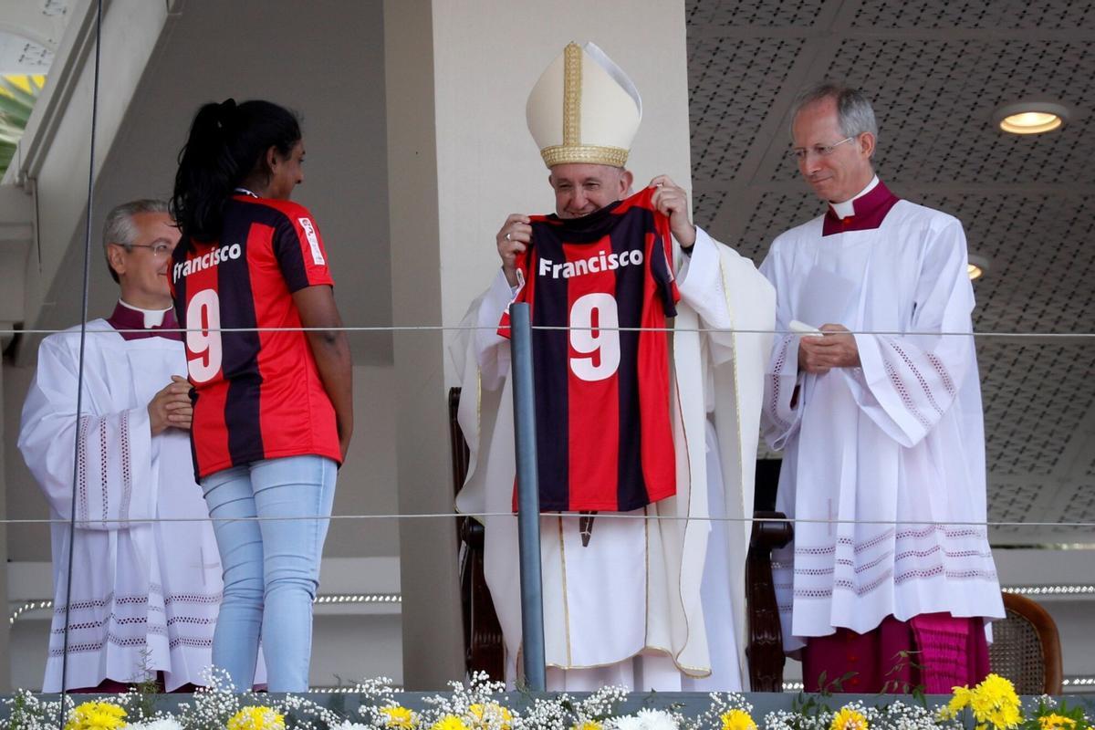Pope Francis smiles upon receiving a shirt from his favorite football team, San Lorenzo Argentino, in 2019.