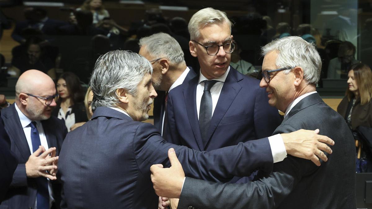 El ministro de Interior español, Fernando Grande Marlaska, saluda al comisario europeo de migración, Magnus Brunner, durante una reunión de ministros de la UE.