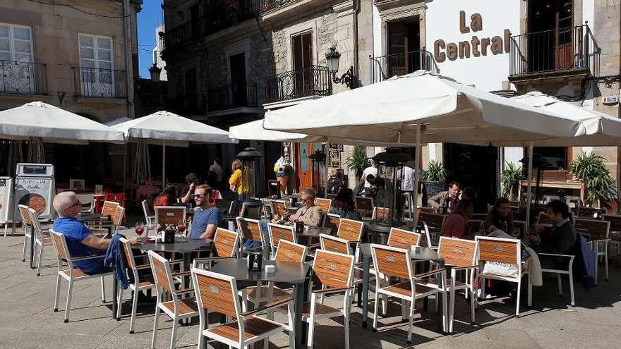 Gente en las terrazas de la plaza de la Constitución, ayer. // Marta G. Brea