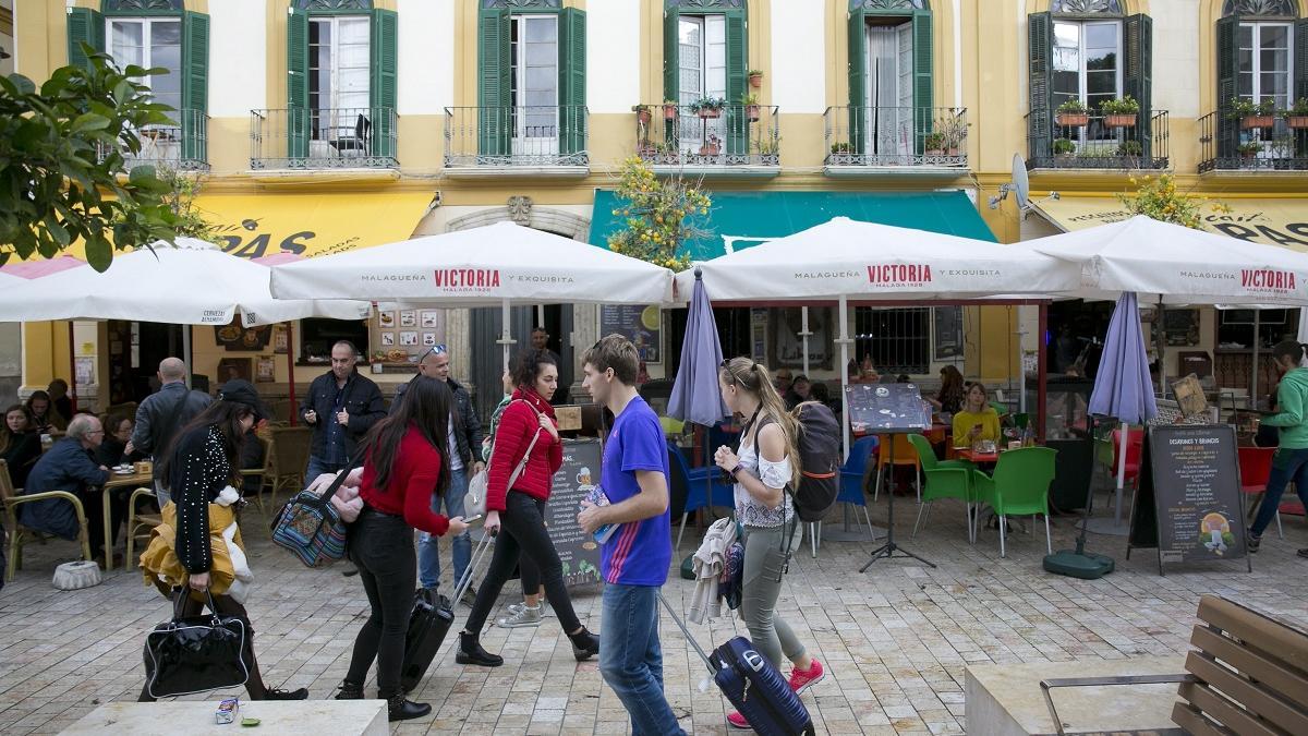 Turistas con sus maletas en la plaza de la Merced.