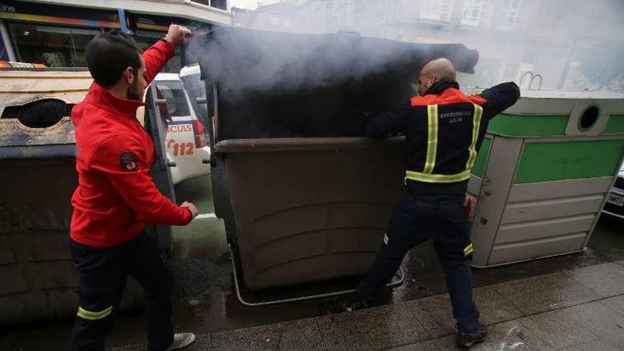 Dos efectivos del GES apagan el fuego del contenedor. // Bernabé/Gutier