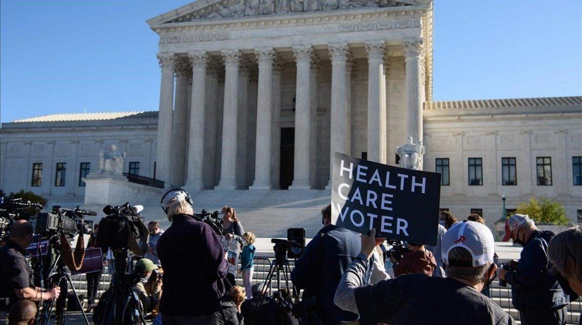 undefined55828891 a demonstrator holds a sign in front of the us supreme court201110220159