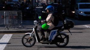 Una moto de Cooltra circula por el paseo de Gràcia, este martes