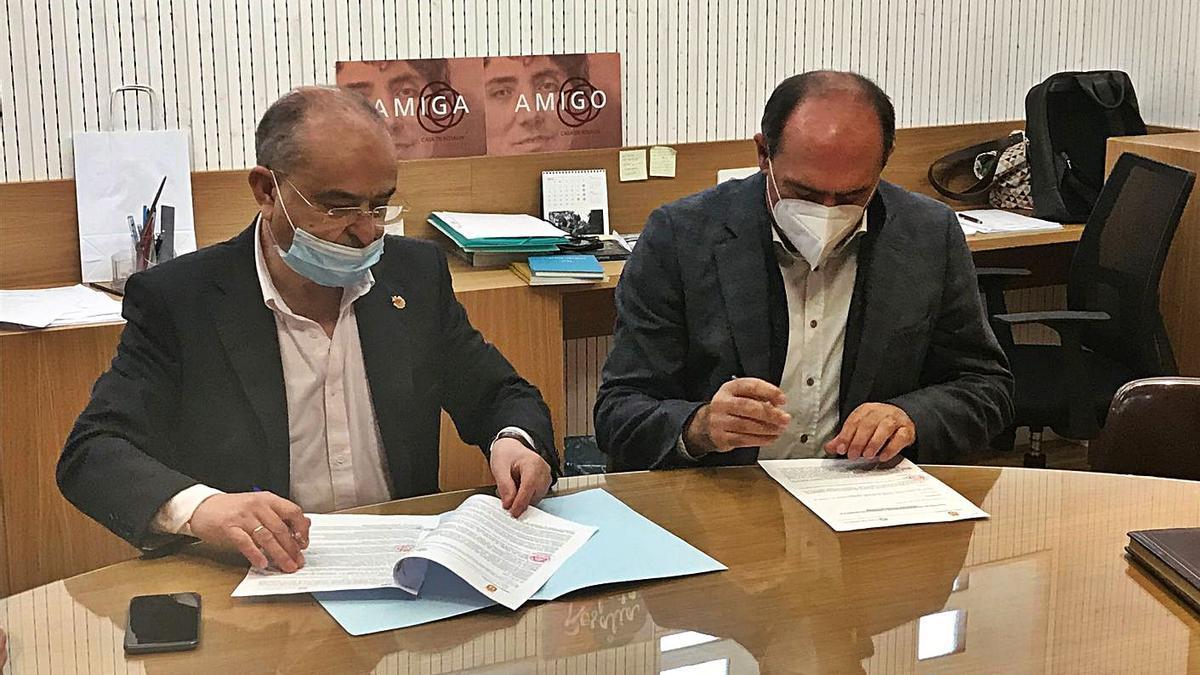 El alcalde de Catoira, Alberto García, a la izquierda, firma el convenio. |   // FDV