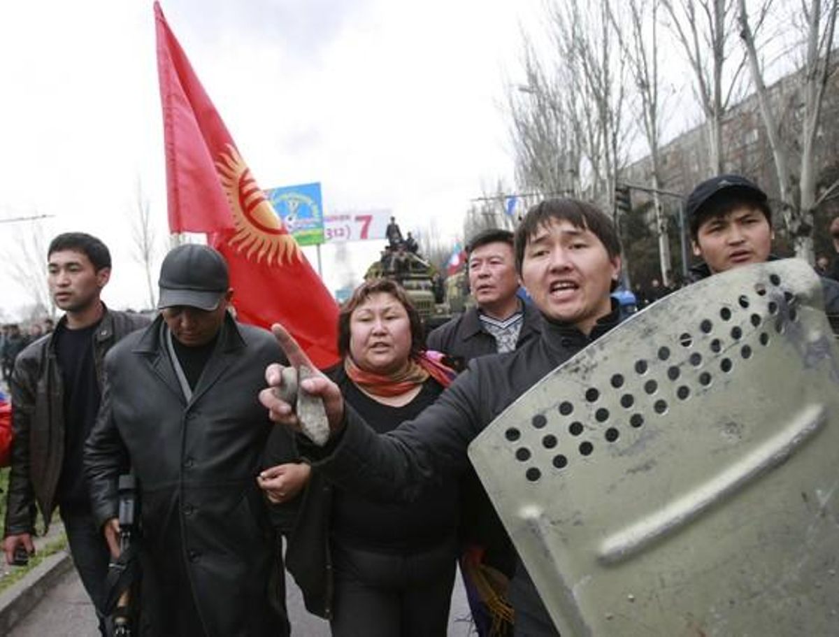 Protesters shout slogans during clashes with riot police in Bixkek