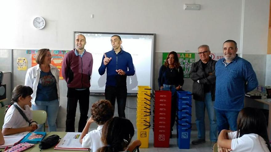 Momento en que se efectúa la entrega de las papeleras al colegio