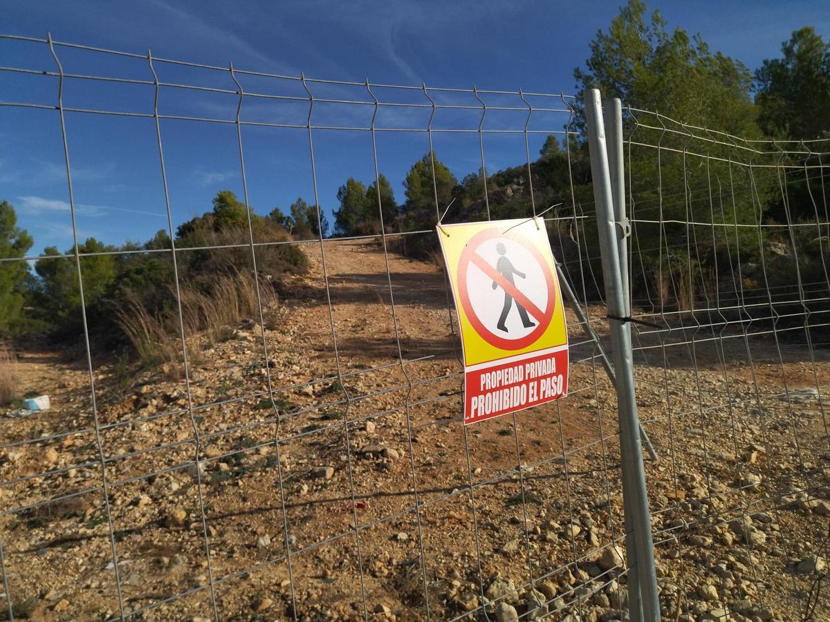 Valla y cartel de prohibido el paso a la ladera donde la empresa ha iniciado las obras del PAI