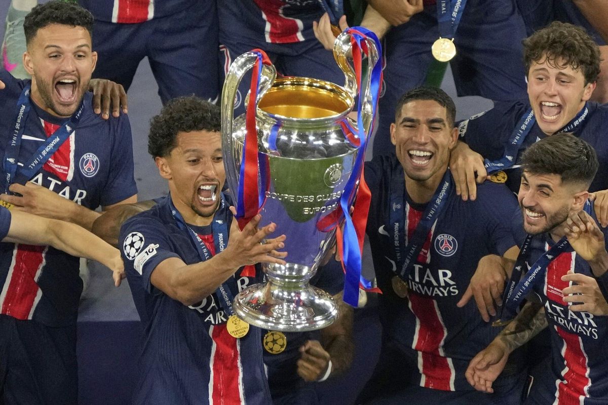 PSG players celebrate with the trophy after winning the Champions League final soccer match between Paris Saint-Germain and Inter Milan at the Allianz Arena in Munich, Germany, Saturday, May 31, 2025. (AP Photo/Michael Probst)