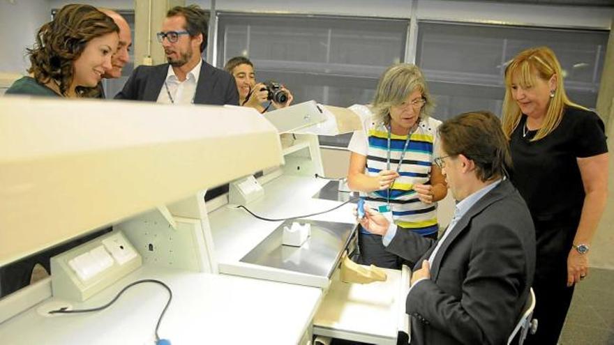 Antoni Llobet, regidor d&#039;Universitats, assegut davant la taula de treball d&#039;un dels laboratoris