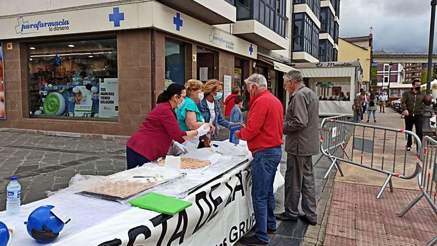 Reparto de tarta venera, ayer, en Navia. | A. M. S.