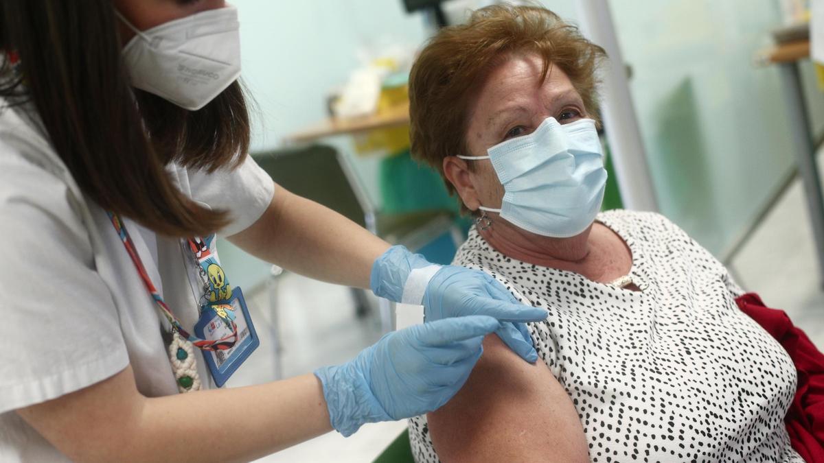 Una sanitaria vacuna a una mujer contra el cocornavirus.