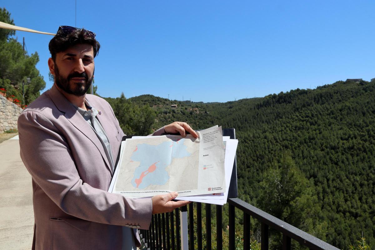 L'alcalde de Rubió mostra un plànol del municipi on es veu gairebé tot el terme marcat de color blau, que significa 'apte' per a instal·lar energies renovables