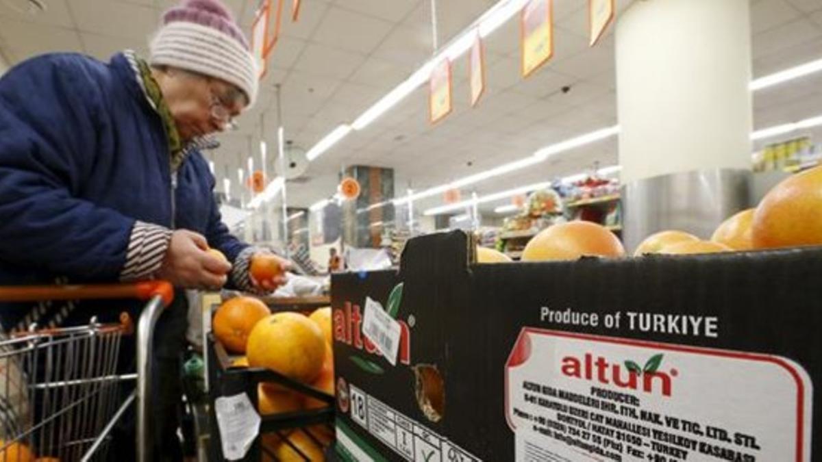 Una mujer comprueba los pomelos, importados de Turquía, a la venta en un comercio de Moscú, este martes.