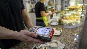 Un dependent d’hostaleria cobra amb un datàfon