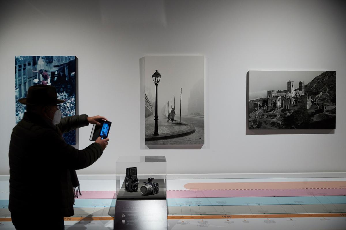 Un visitante toma fotos, en la exposición ’Els Català, fotògrafs d’un segle’.