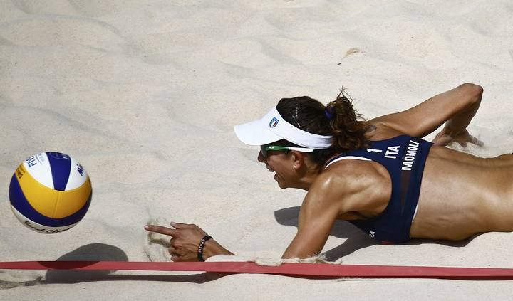 Momoli of Italy dives for the ball during their preliminary beachvolleyball match against Belarus at the 1st European Games in Baku