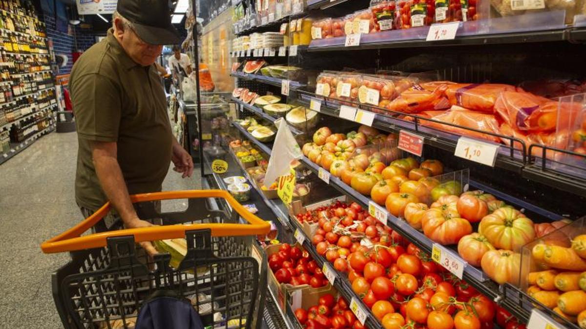 Un consumidor en el pasillo de las frutas y verduras de un supermercado.