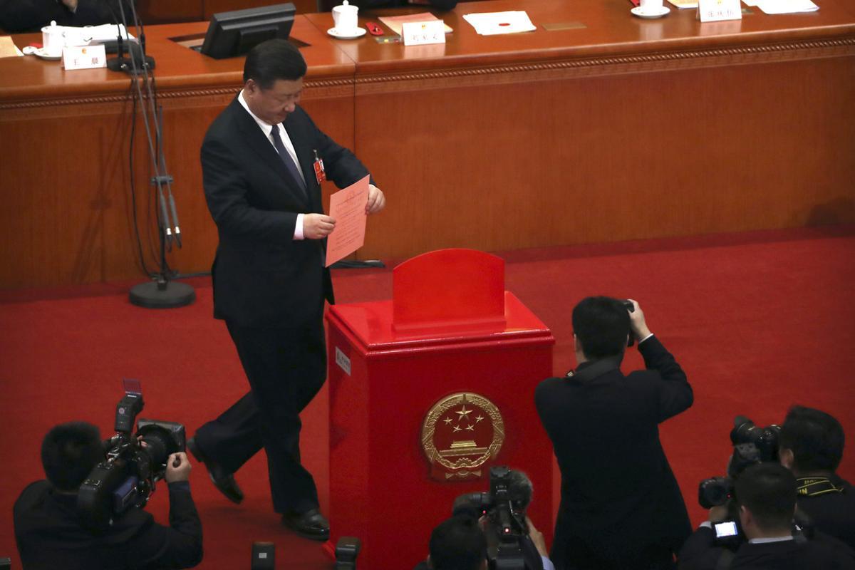 Chinese President Xi Jinping places his ballot in a ballot box during a plenary session of China’s National People’s Congress (NPC) at the Great Hall of the People in Beijing, Sunday, March 11, 2018. China’s rubber-stamp lawmakers on Sunday passed a historic constitutional amendment abolishing presidential term limits that will enable Xi to rule indefinitely. (AP Photo/Mark Schiefelbein)