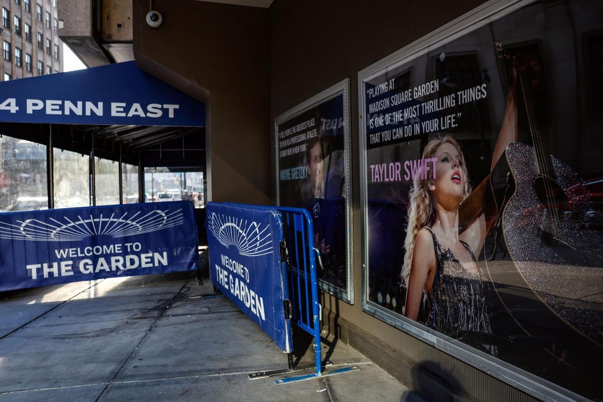 A poster featuring an image and quote from US singer-songwriter Taylor Swift is displayed outside Madison Square Garden in New York on July 1, 2026. Increasing signs point to a mega-bash for the A-list celebrity couple Taylor Swift and Travis Kelce at Madison Square Garden this week. Rumors have run rampant for weeks that the 36-year-old pop superstar and the three-time NFL Super Bowl winner, both 36, could wed at the storied sports arena, home to the New York Knicks, the newly crowned NBA champions. (Photo by kena betancur / AFP)