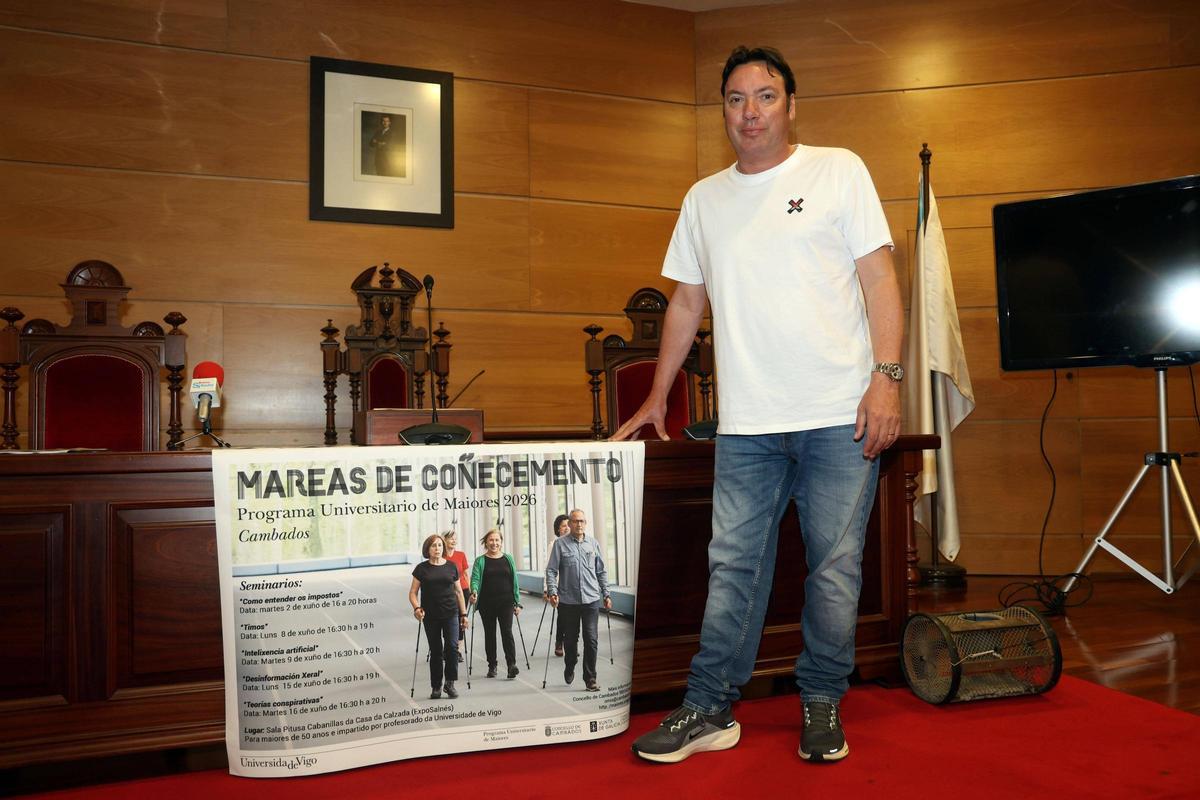 El teniente de alcalde con el cartel de los nuevos cursos para Cambados.