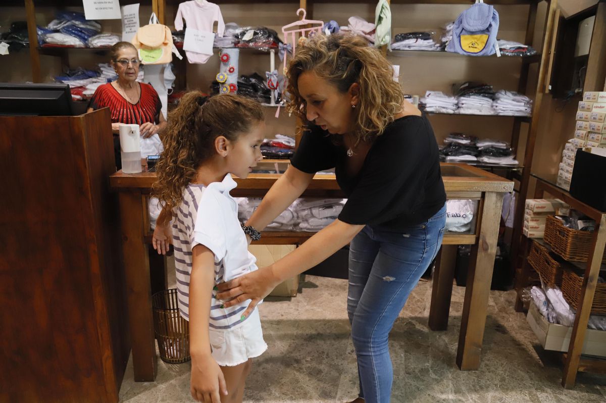 Una niña se prueba un uniforme escolar en la tienda Temola de Córdoba.