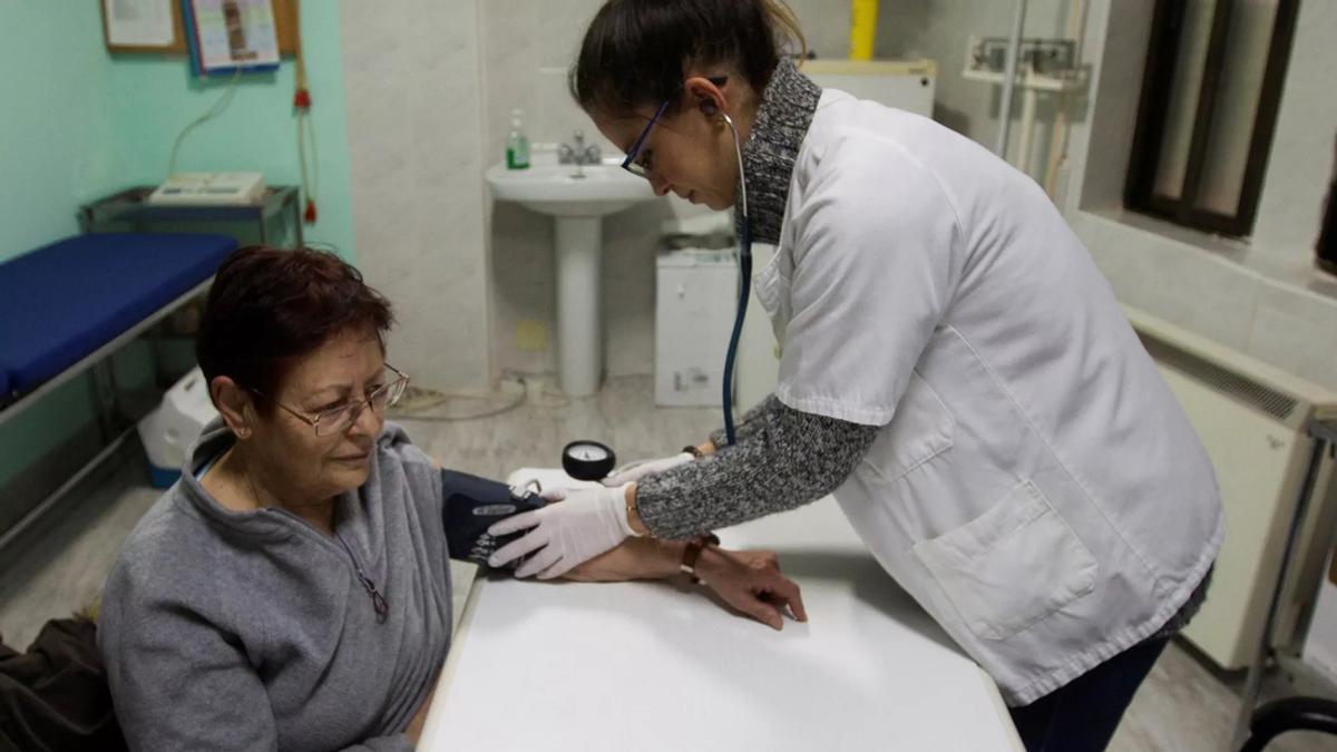 Una sanitaria atiende a una paciente en un centro de salud.