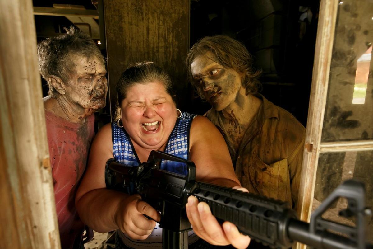 Tourist Amy Powers is approached by Walker Matthew Tomlin during The Walking Dead Tour of a Season 3 location of the AMC production in Haralson, Georgia, U.S. June 15, 2019. Picture taken on June 15, 2019.  REUTERS/Chris Aluka Berry     TPX IMAGES OF THE DAY