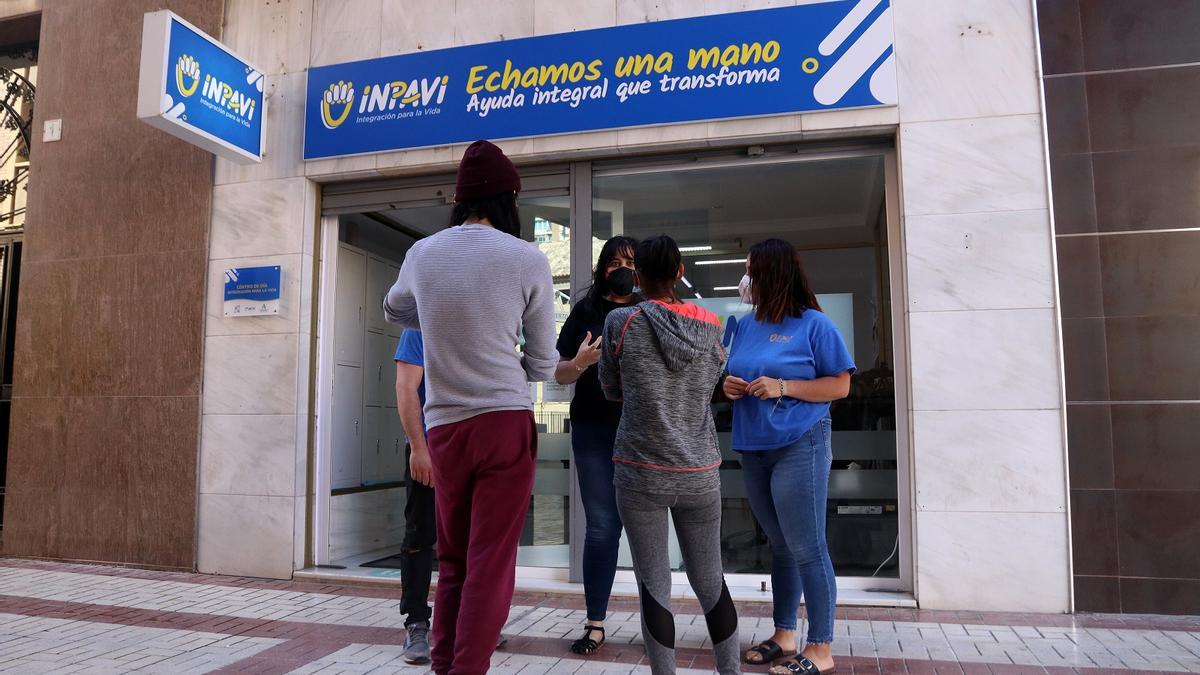 Voluntarios del centro de día de INpavi charlan con dos usuarios.