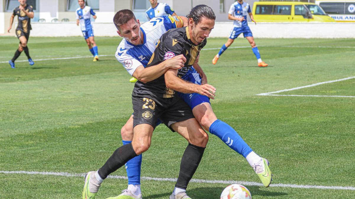 Aarón Piñán, autor del gol del Intercity, pugna con el capitán del Sabadell