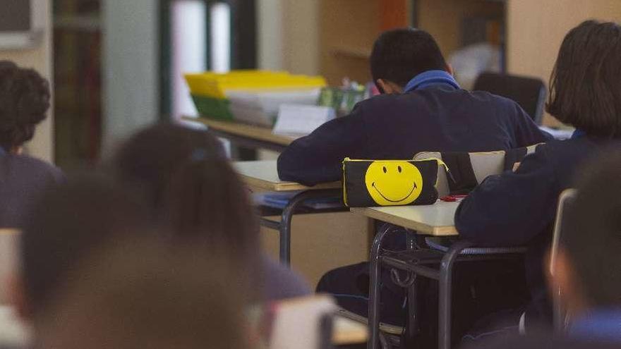 Un grupo de niños hace sus deberes en el aula de un colegio.