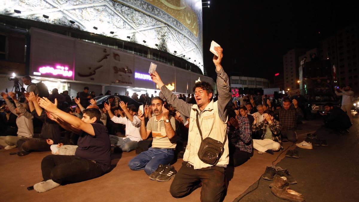 Cientos de personas rezan en las calles de Teherán tras conocerse la muerte del presidente Raisi.