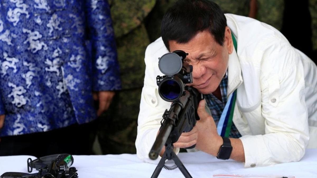 Duterte comprueba la mirilla de un rifle, hace unos días,