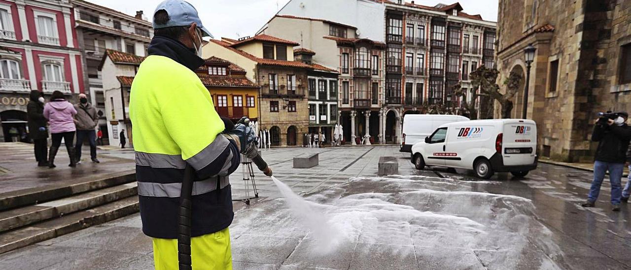 Un empleado de la limpieza de Avilés baldea el pavimento de la campa de San Francisco. | Ricardo Solís