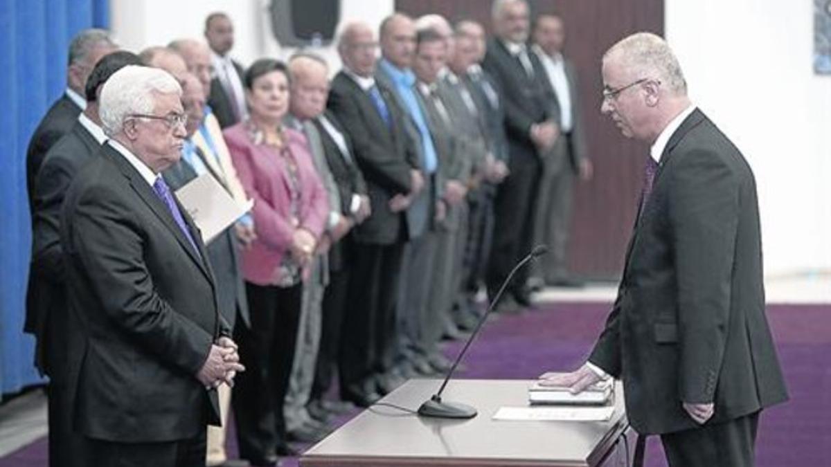 Abbás, a la izquierda, toma juramento al primer ministro Rami Hamdala.