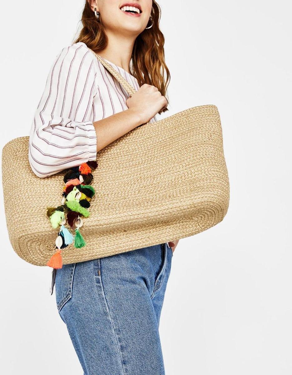 Bolso de yute con pompones de Bershka (29,99 euros)