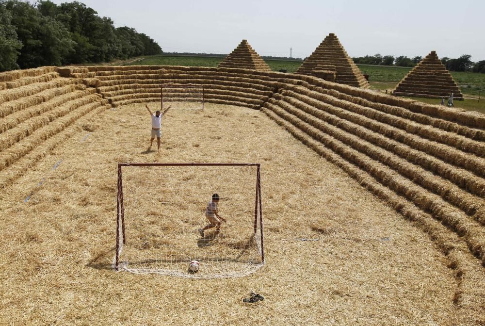 People visit an amusement park made of straw at ...