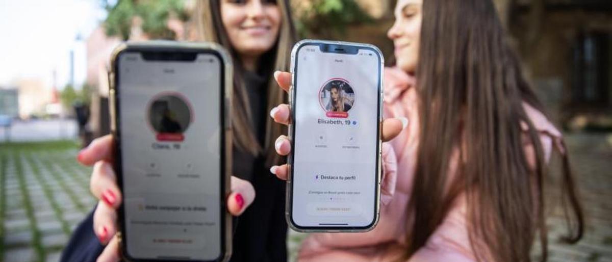 Dos jóvenes muestran su perfil de Tinder.