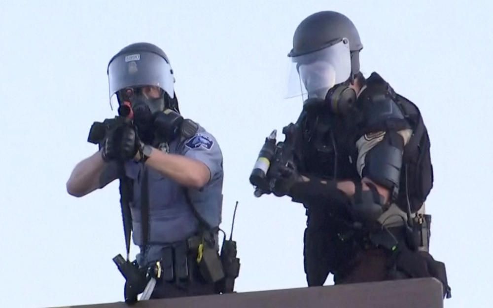 Police aim at a Reuters TV cameraman during ...