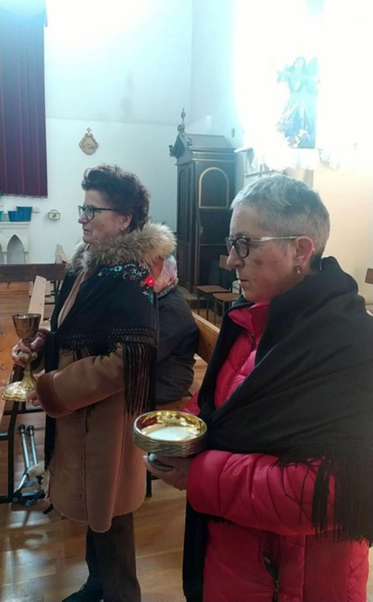 Arriba celebración en Santa Cristina, con la charanga y abado dos mujeres durante la misa en Santovenia del Esla. | E. P.