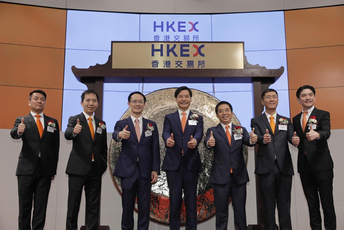 From Left to right, Xiaomi’s Co-Founders, Wang Chuan, Hong Feng, Lin Bin, Lei Jun, Li Wanqiang, Liu De, Wong Kong Kat, pose for pictures during the listing ceremony at the Hong Kong Stock Exchange in Hong Kong Monday, July 9, 2018. Chinese smartphone maker Xiaomi Corp. shares have slipped in its first trading day in Hong Kong following a multibillion-dollar initial public offering. (AP Photo/Vincent Yu)