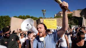 Un hombre usa un megáfono durante la protesta contra el uso de las mascarillas en Madrid