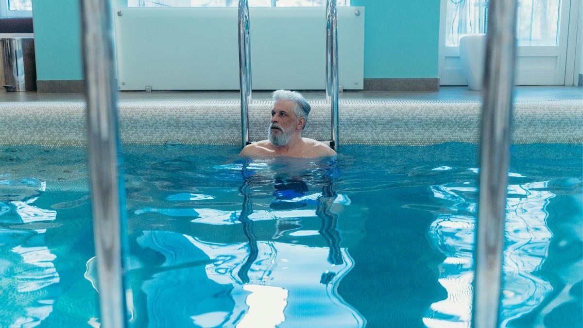 Un hombre en una piscina climatizada