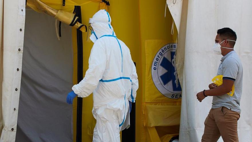 Un sanitario y un paciente entran en el hospital de campaña en Lleida