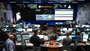 Artemis II controllers monitor the progress of the Orion spacecraft in the White Flight Control Room at Johnson Space Center in Houston, Texas, on April 3, 2026. Four Artemis astronauts were zooming towards the Moon late April 2 after a major engine firing, a milestone that commits NASA to the first crewed lunar flyby in more than half a century. With enough thrust to accelerate a stationary car to highway driving speed in less than three seconds, the Orion capsule engine blasted the astronauts on their trajectory towards the Moon, which they now will loop as part of the 10-day Artemis II mission. (Photo by RONALDO SCHEMIDT / AFP)