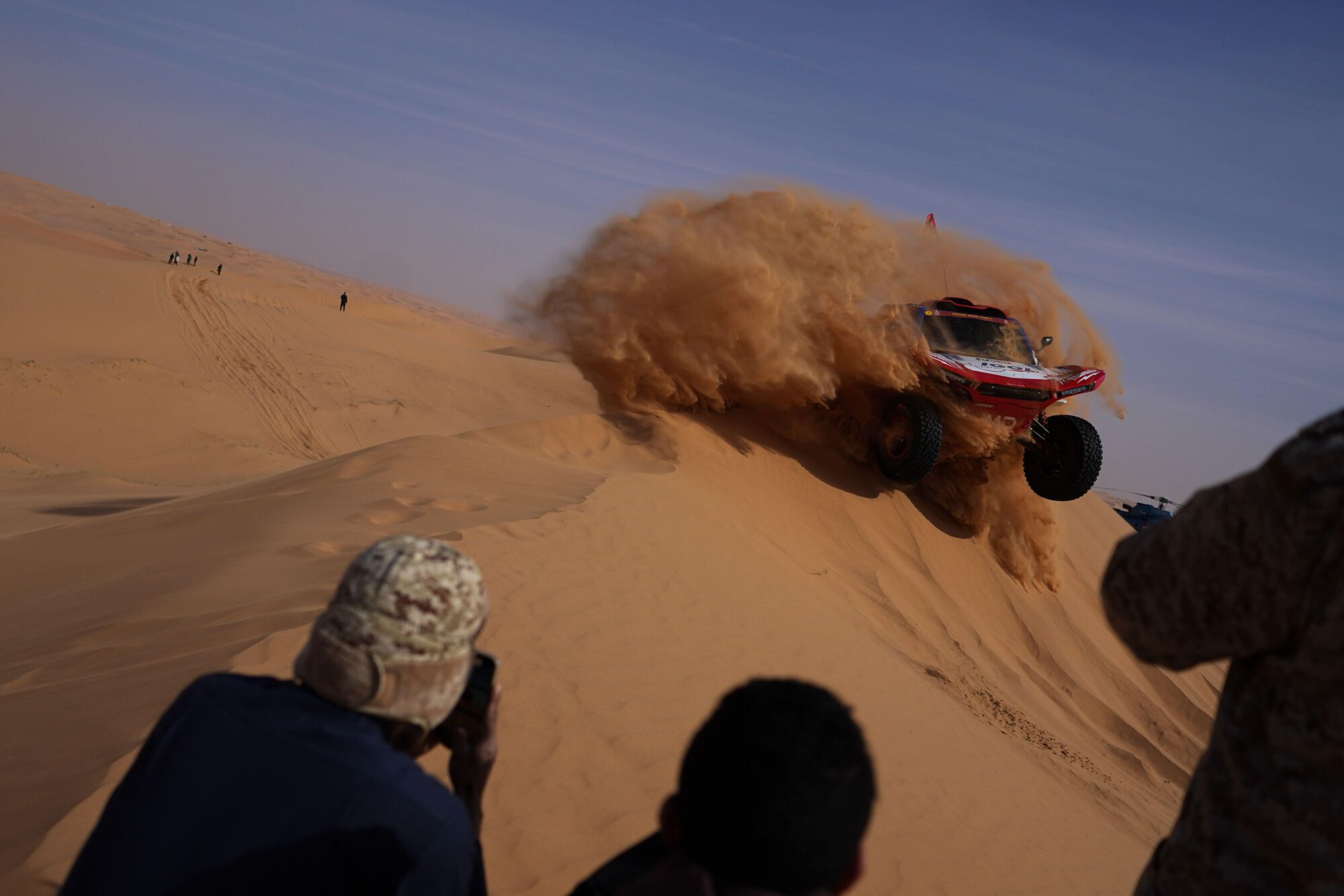 Spectators watch driver Simon Vitse and co-driver Max Delfino competing during the sixth stage of the Dakar Rally between Hail and Riyadh, Saudi Arabia, Friday, Jan. 9, 2026. (AP Photo/Thibault Camus). EDITORIAL USE ONLY/ONLY ITALY AND SPAIN