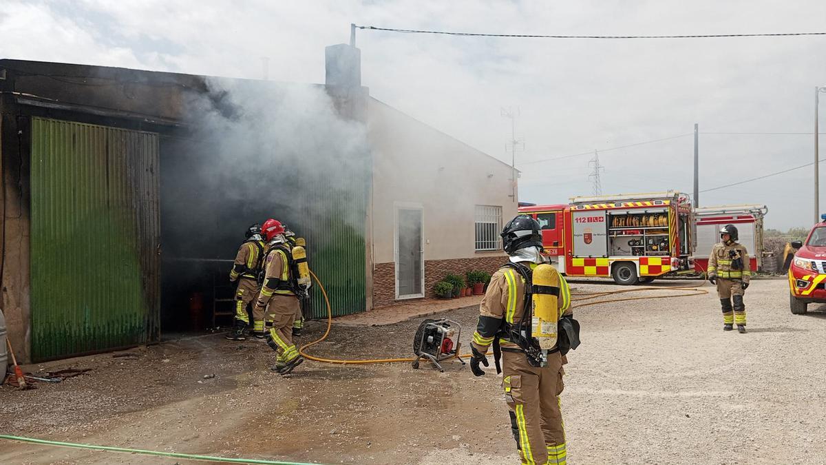 Bomberos del CEIS trabajan para extinguir las llamas del interior de una nave situada en Lorca.