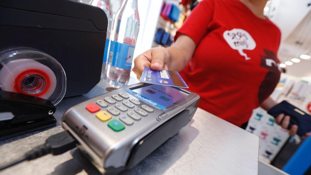 Una mujer paga con una tarjeta de crédito en un establecimiento de Barcelona