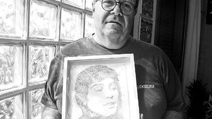 Alberto Andreotti sostiene un retrato de su hermano, el único recuerdo material que conserva de él. / gonzalo núñez