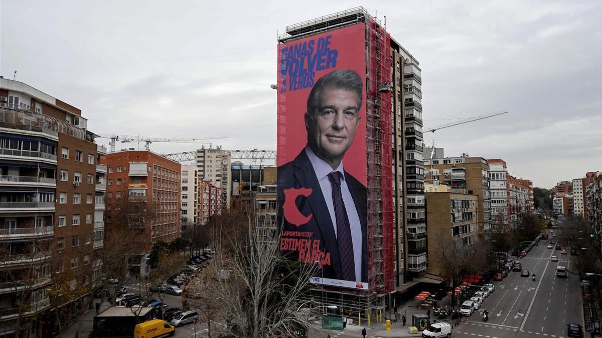 A giant electoral poster of candidate for presidency of FC Barcelona Joan Laporta is displayed on a building next to the Santiago Bernabeu Stadium in Madrid on December 16  2020  - Barcelona will hold elections for a new president on January 24   following former chief Josep Maria Bartomeu s resignation early this year  One of the front runners Joan Laporta  was at the helm of Barca from 2003-2010  a period which included four La Liga titles and two Champions League triumphs  (Photo by OSCAR DEL POZO   AFP)