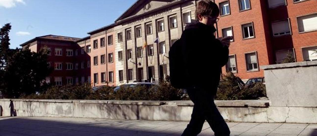 Una joven pasa por delante de la Facultad de Ciencias, en Oviedo.